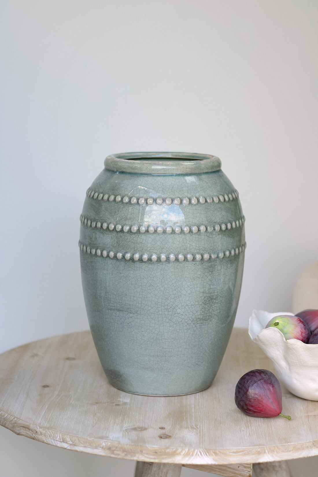 teal bobble vase on wooden table