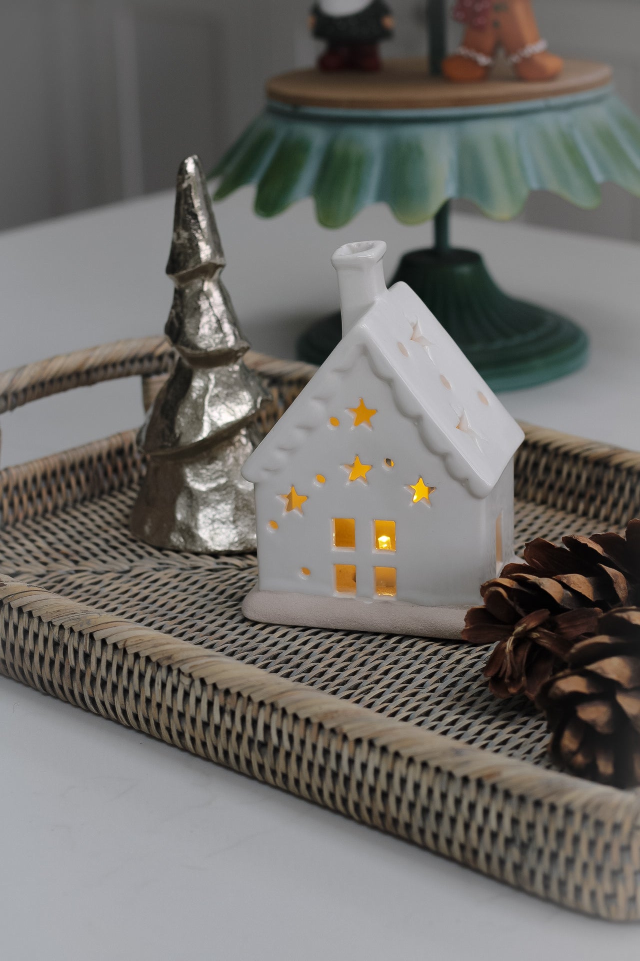 rattan tray with ceramic house and silver christmas tree for home decor