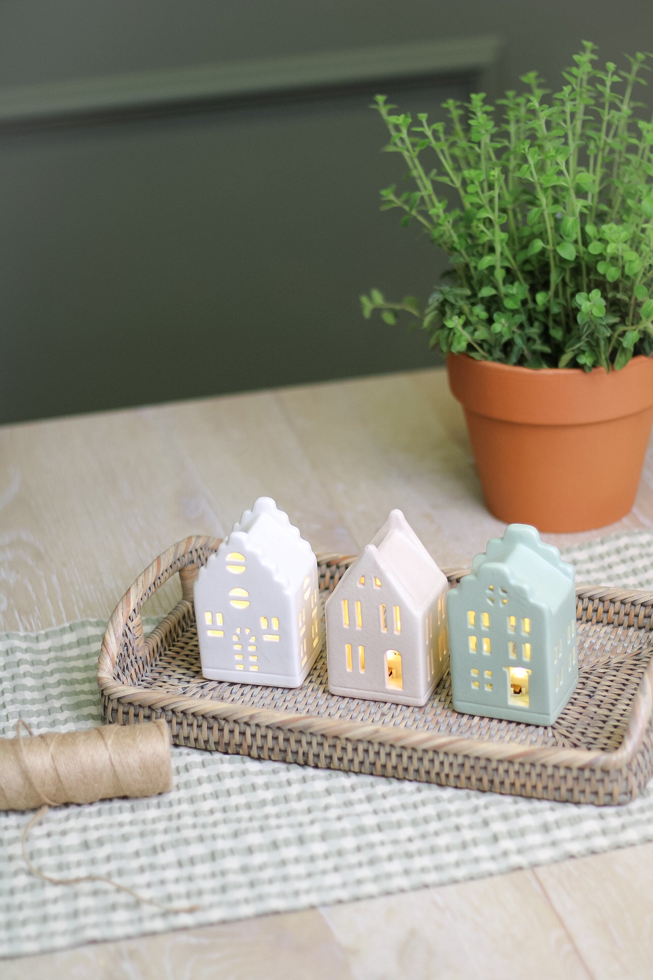 led houses lit up on wicker tray