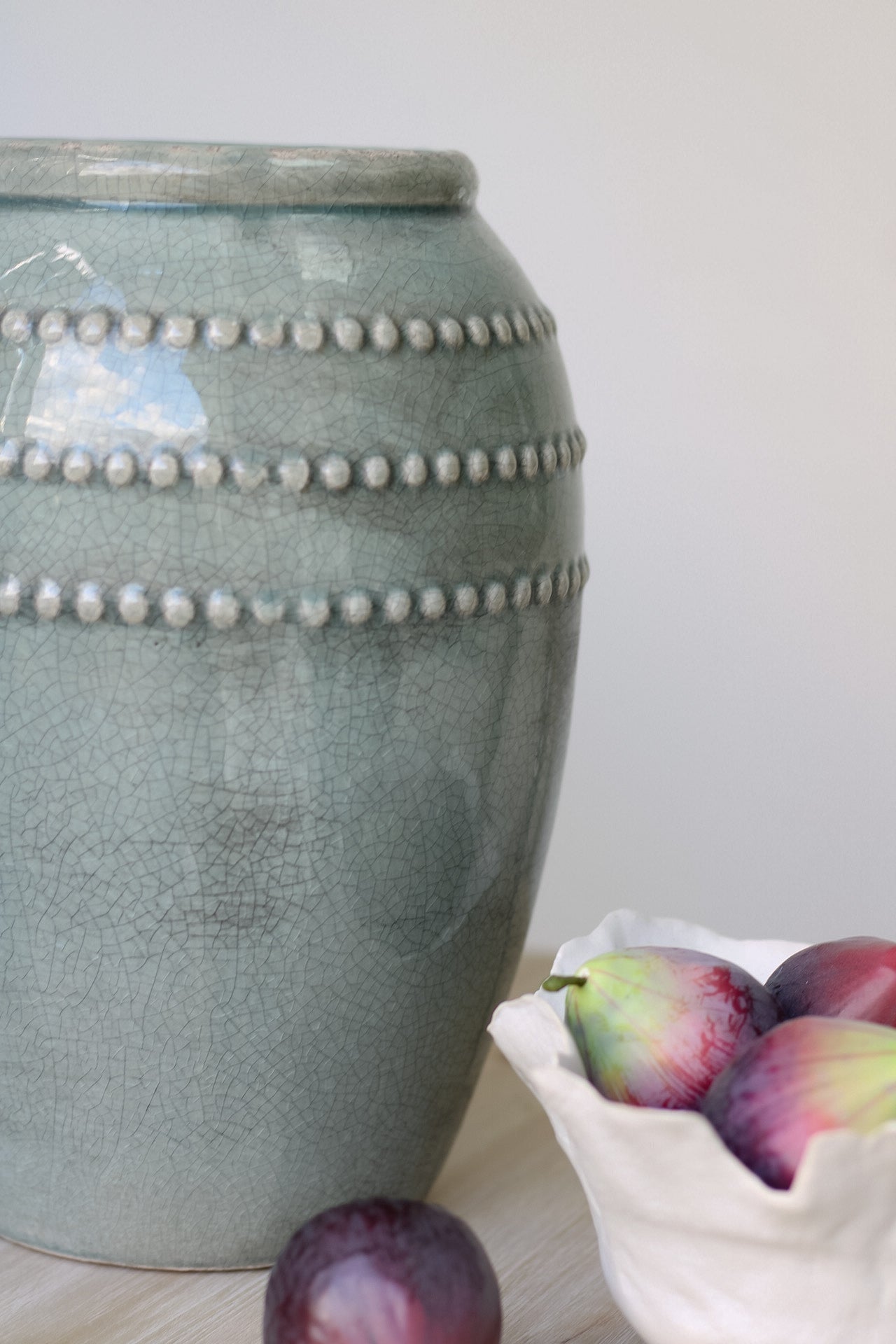 close up of tall teal vase