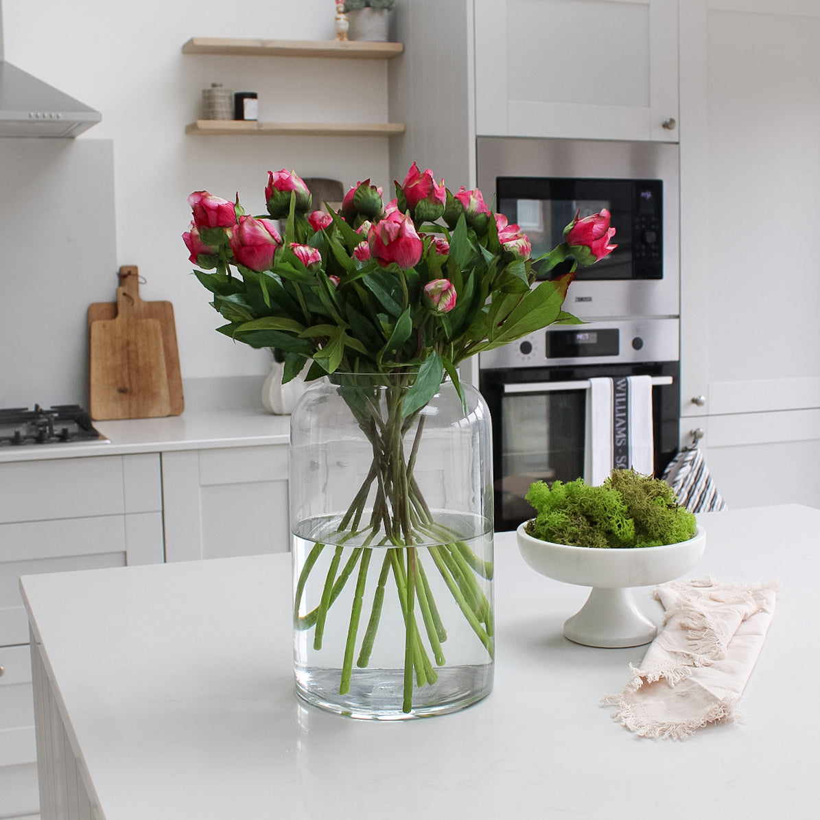 faux fuchsia peonies in glass apothecary vase for home decor