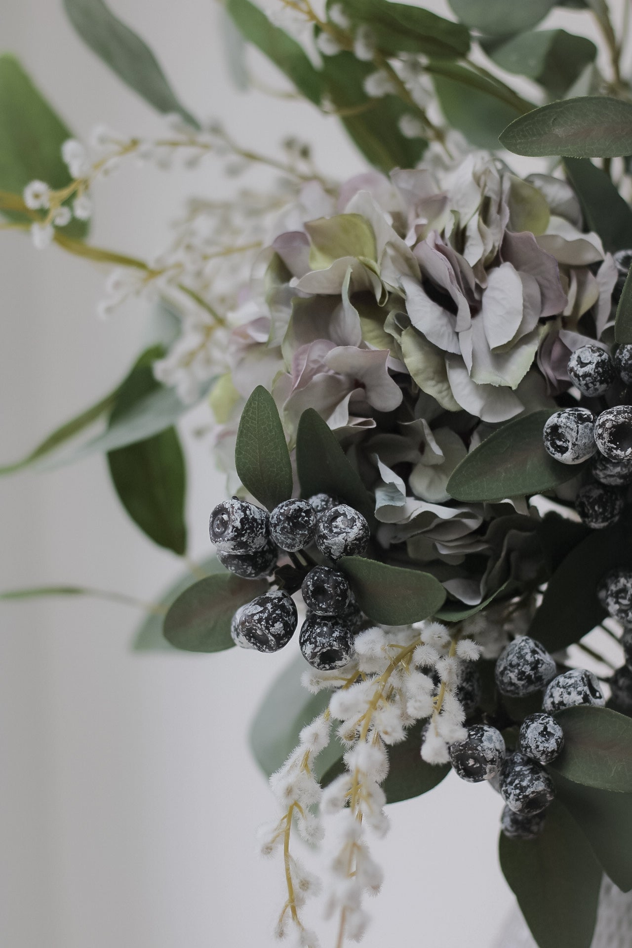 Up close of faux berried eucalyptus stem. Introduce faux winter eucalyptus to your christmas decor.