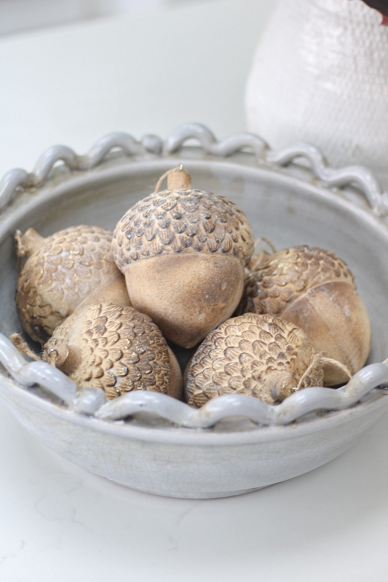 bowl of wooden acorns for christmas decor