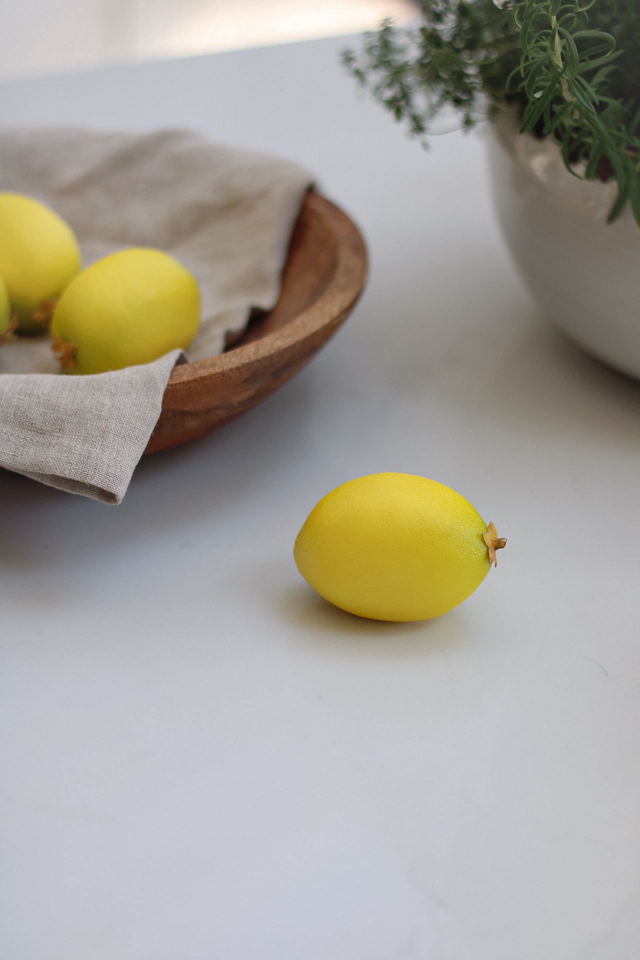 Decorative Faux Lemon on white worktop