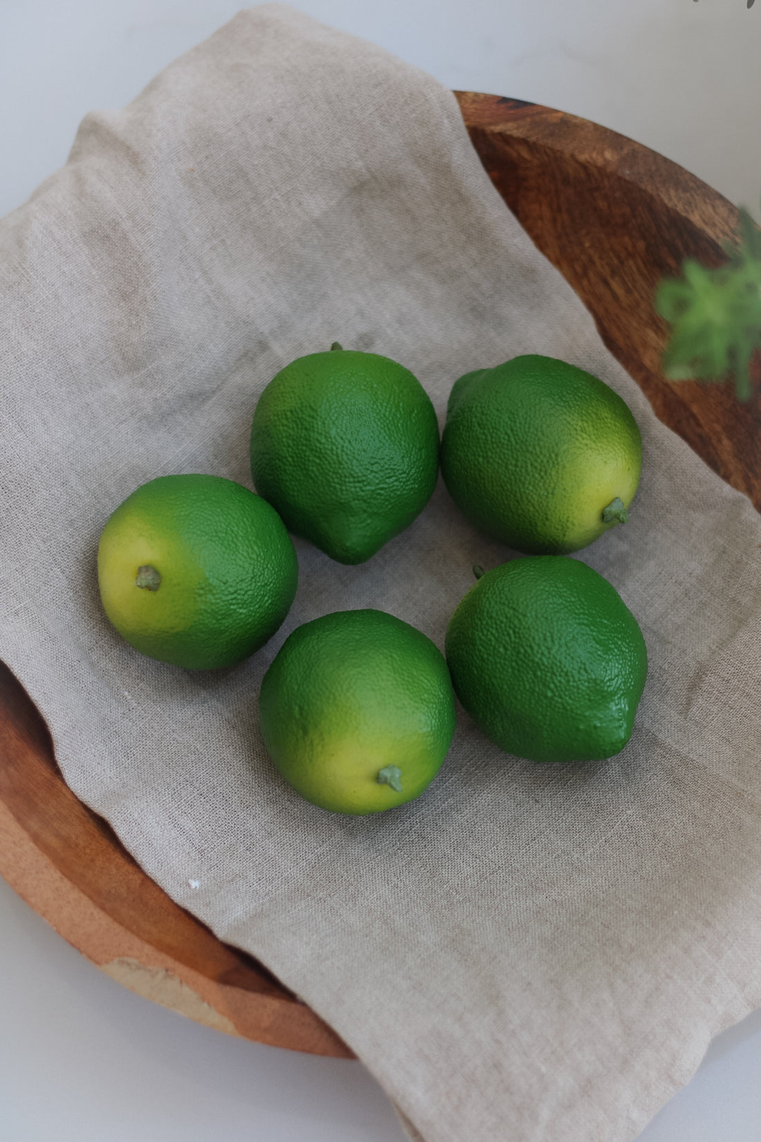 Decorative Faux Limes in wooden bowl