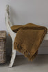 Olive green tasselled throw for cosy home decor