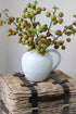 Eversley White Rustic Jug filled with faux crab apple stems. Introduce country charm to your home decor.