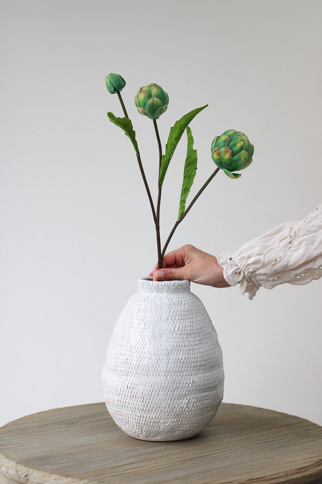 Single Faux Artichoke Spray in textured rustic vase