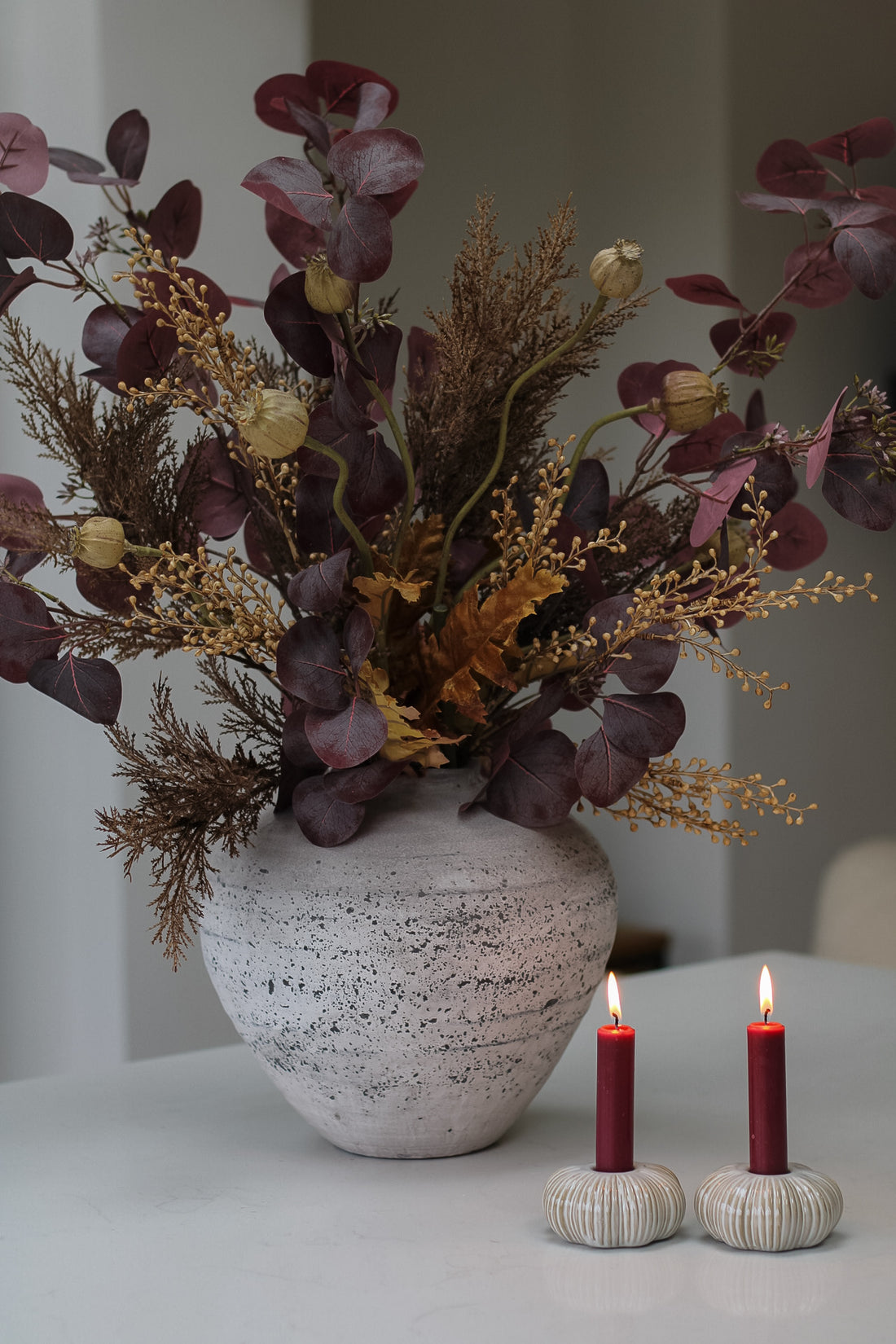 Faux rustic autumn foliage arrangement in stone vase