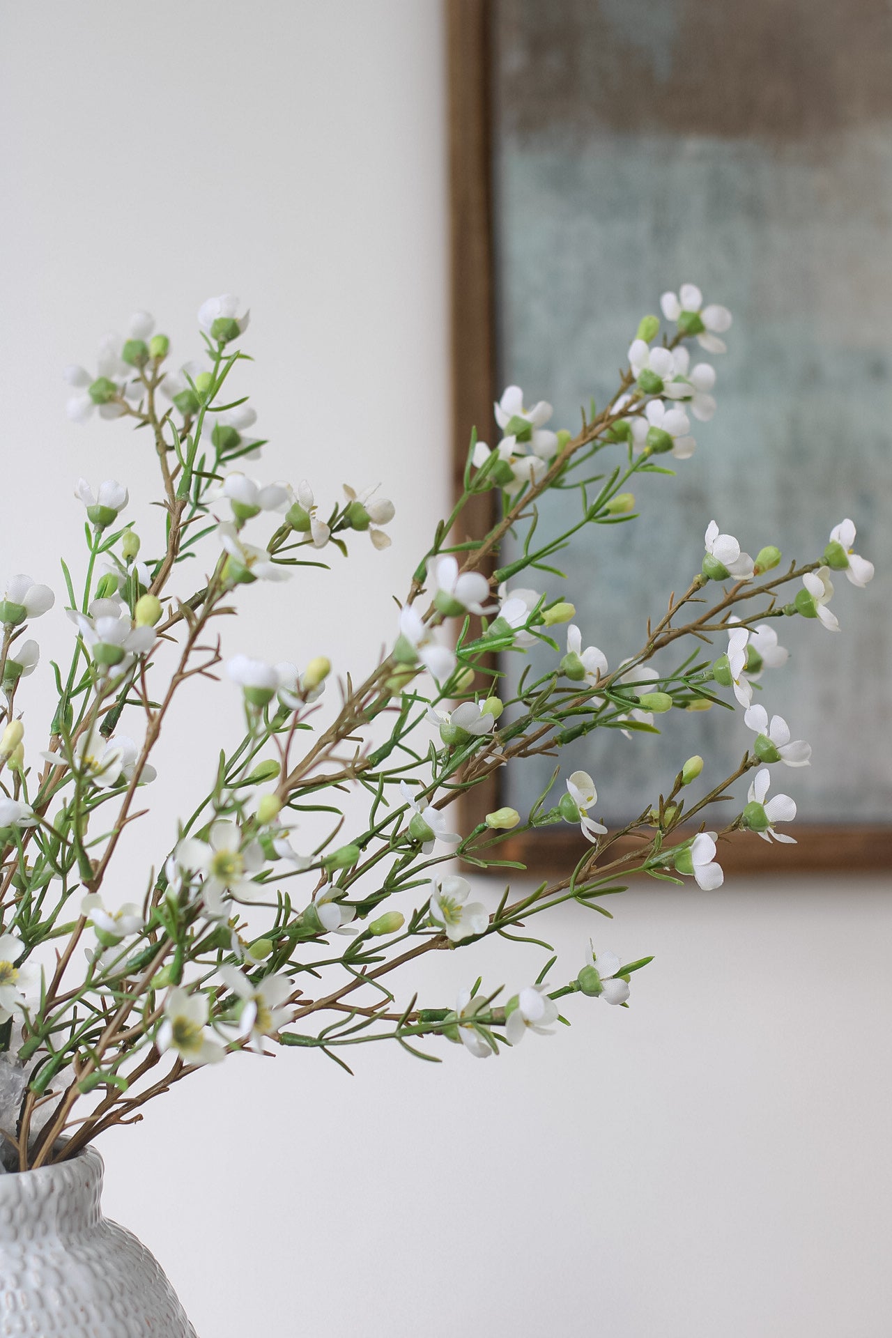 Faux white wax flower pair with elegant ceramic vases