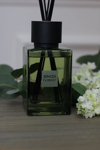 close up of Florist Sences Reed Diffuser next to flowers