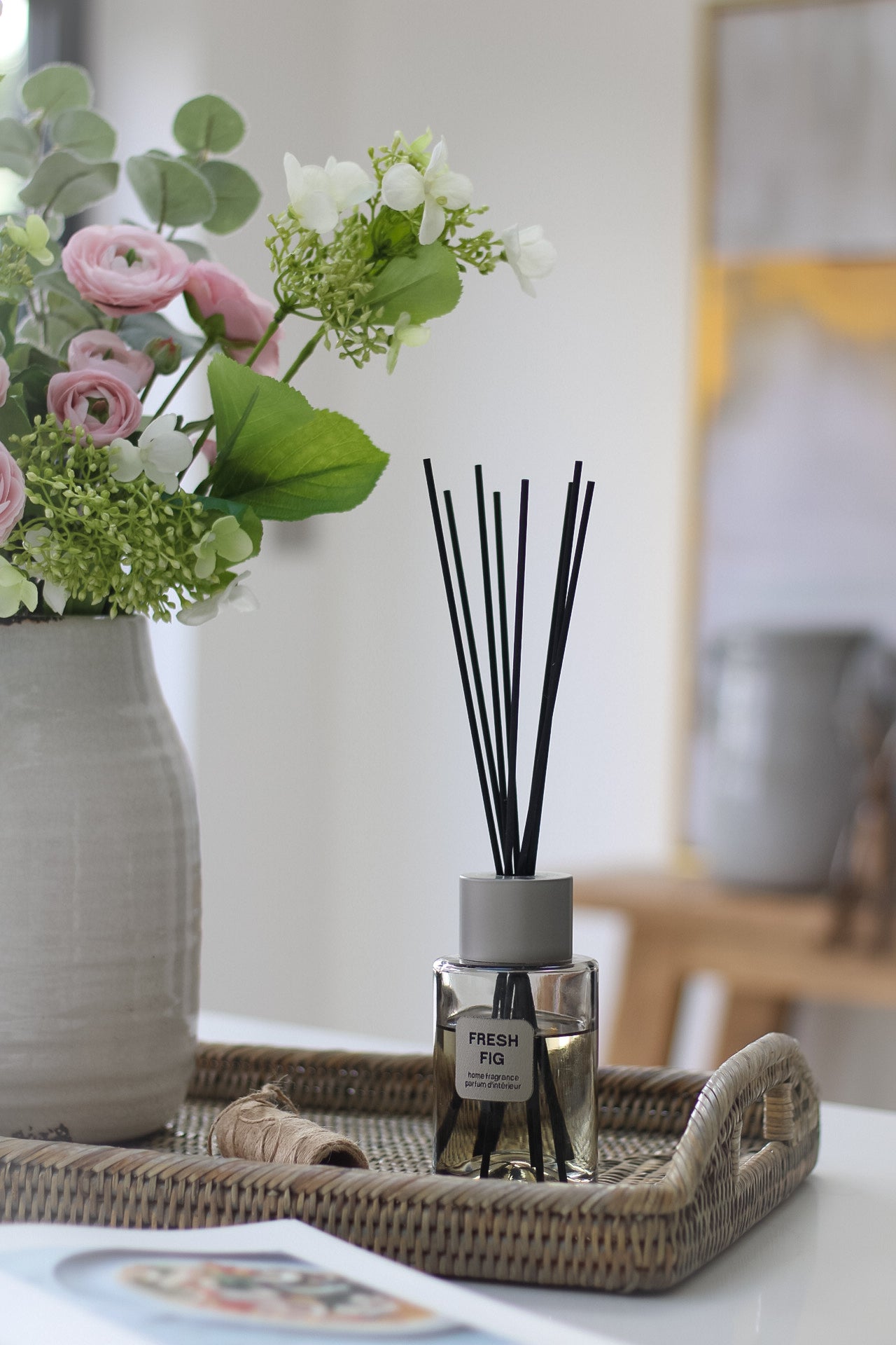 Fresh Fig Reed Diffuser sat on top of rattan tray