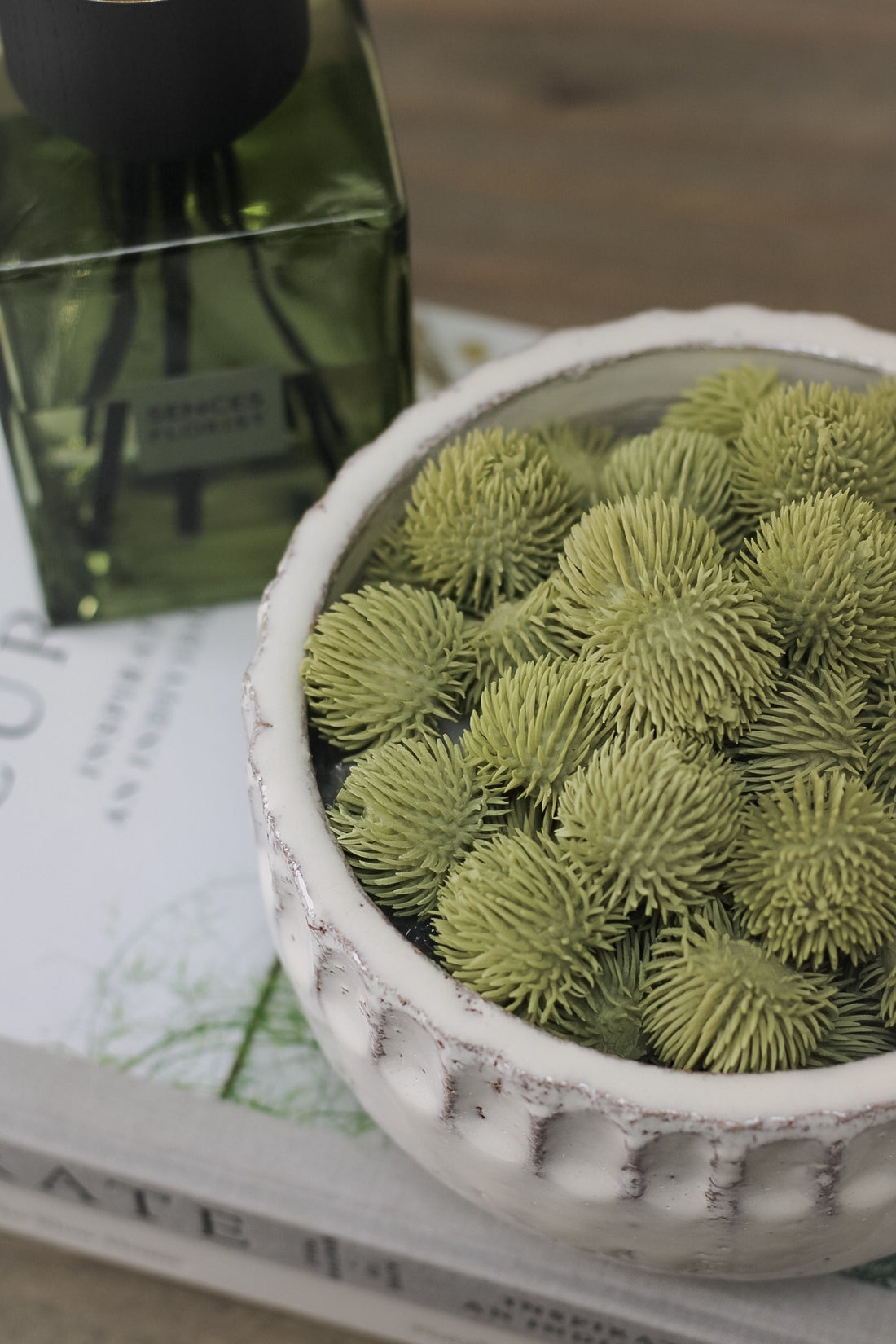 Green Echinops Balls in rustic textured bowl for beautiful home decor