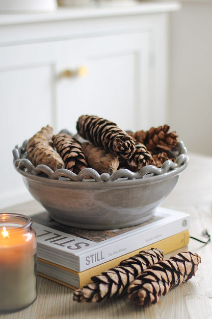 Grey Ceramic bowl filled with pine cones