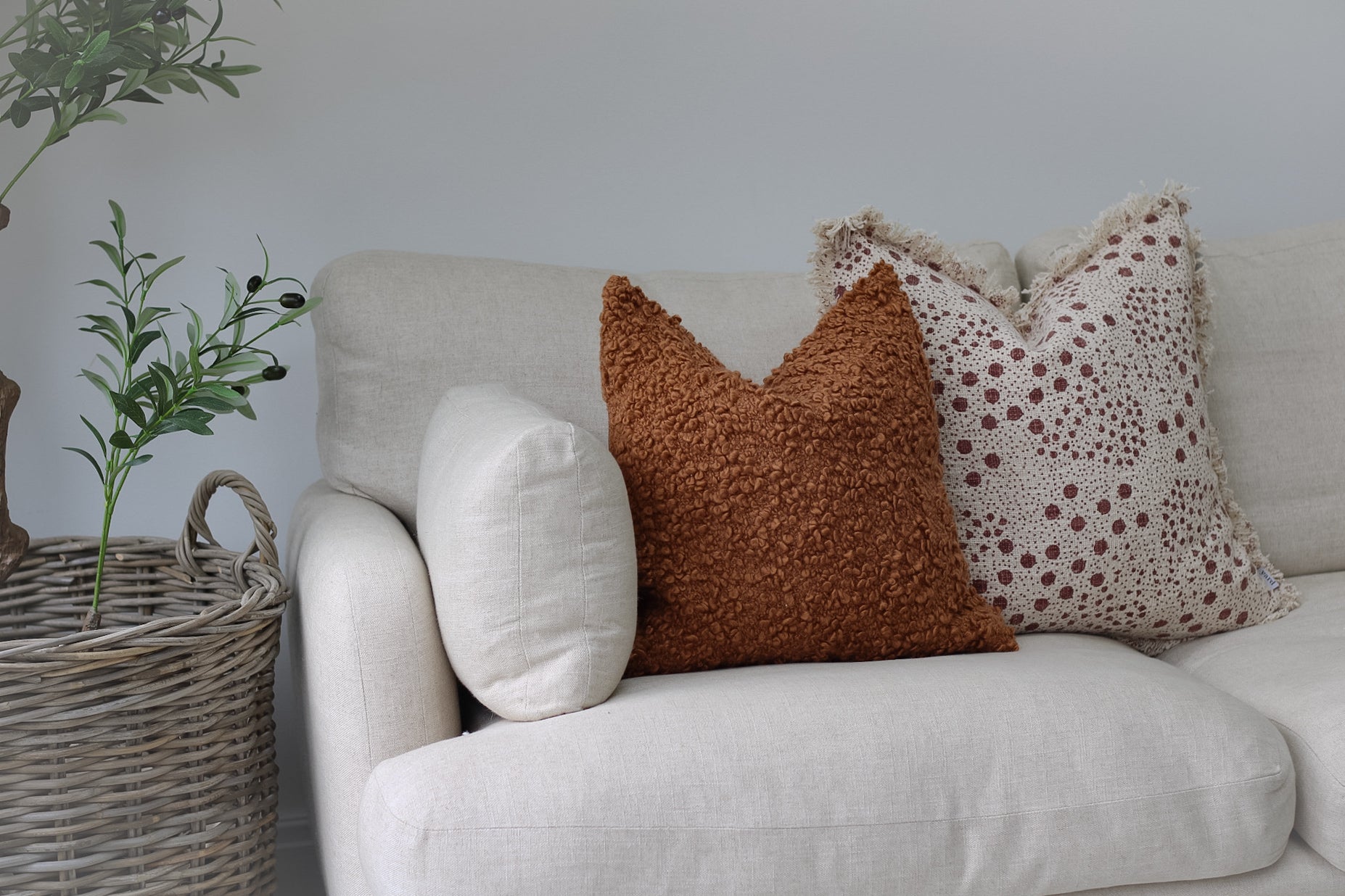 sofa with ginger boucle cushion and dotty fringed cushion for home decor