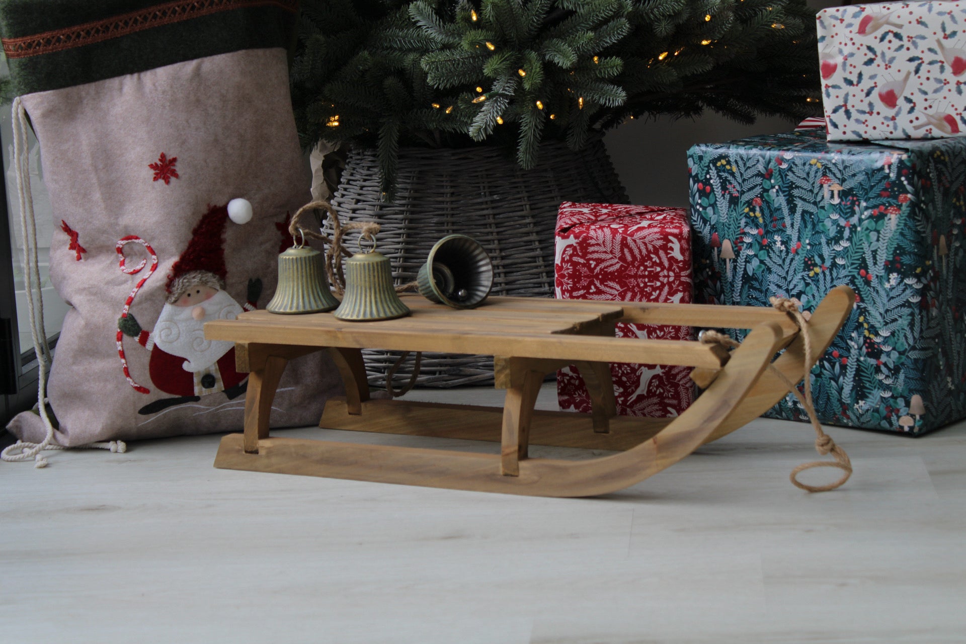 Wooden sleigh and presents under tree for christmas decorations