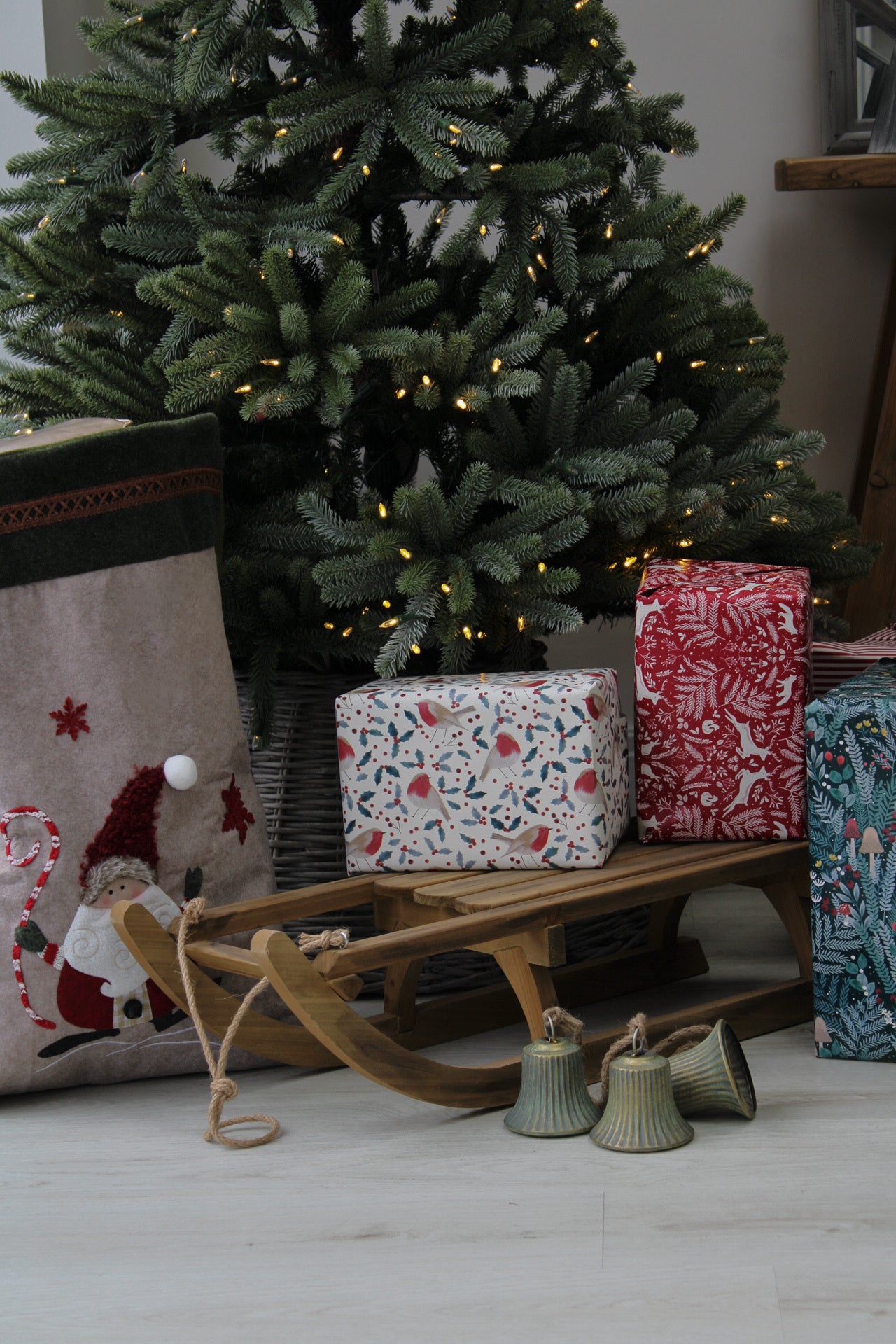 Wooden sleigh and presents under tree for christmas decorations