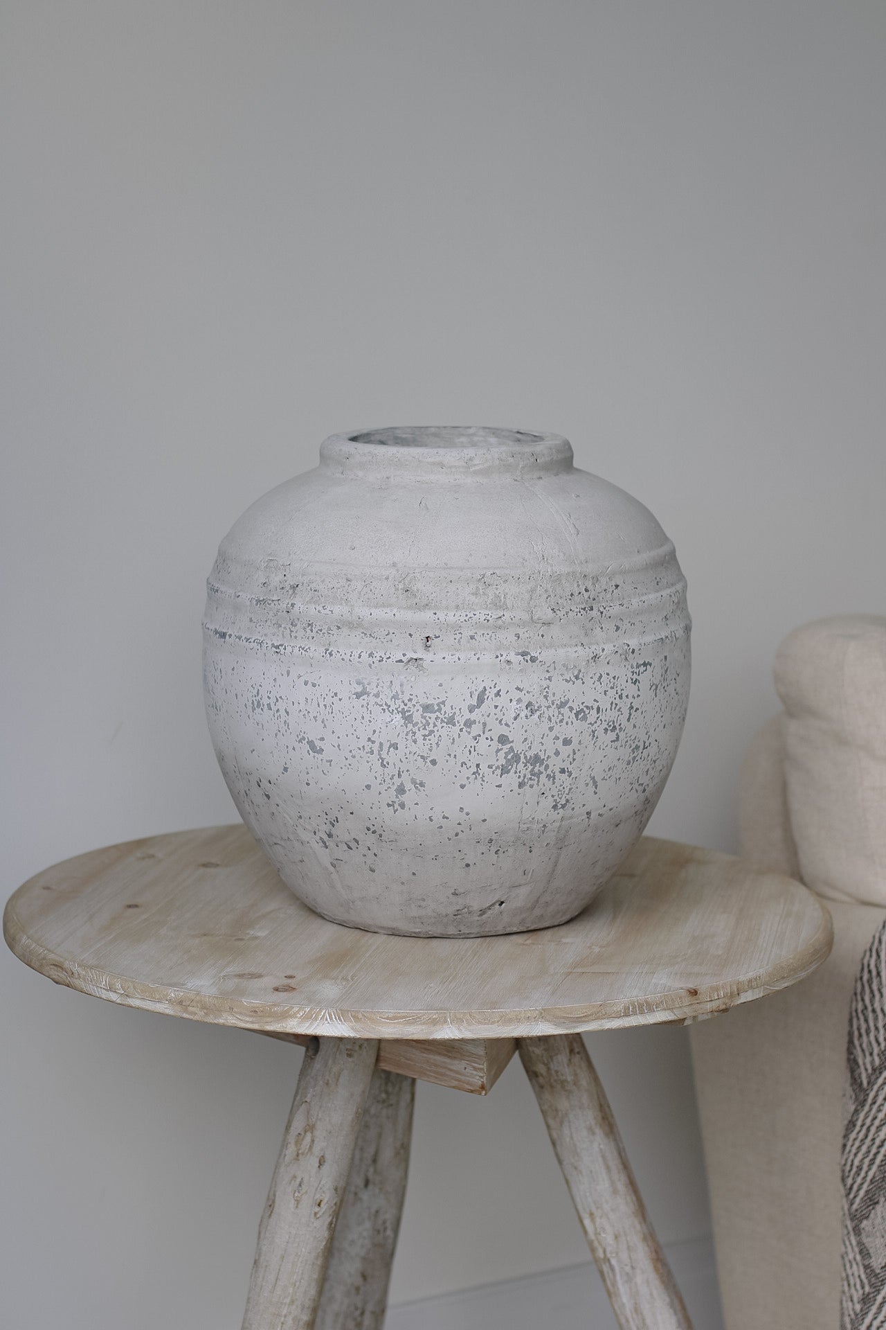 Stone vase on wooden side table