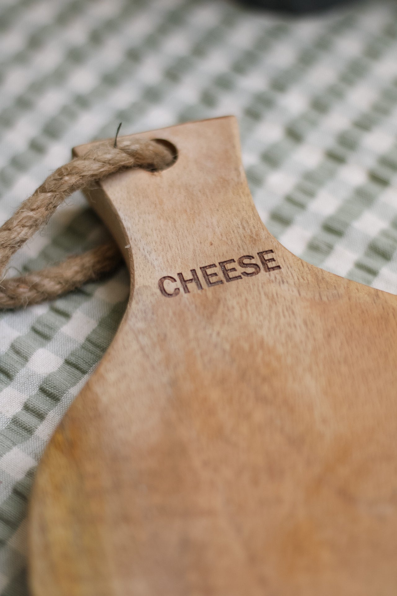 etched cheese text on wooden chopping board