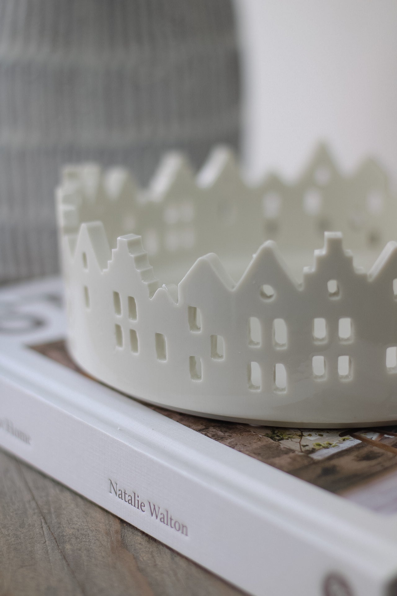 up close of white ceramic winter house scene tray