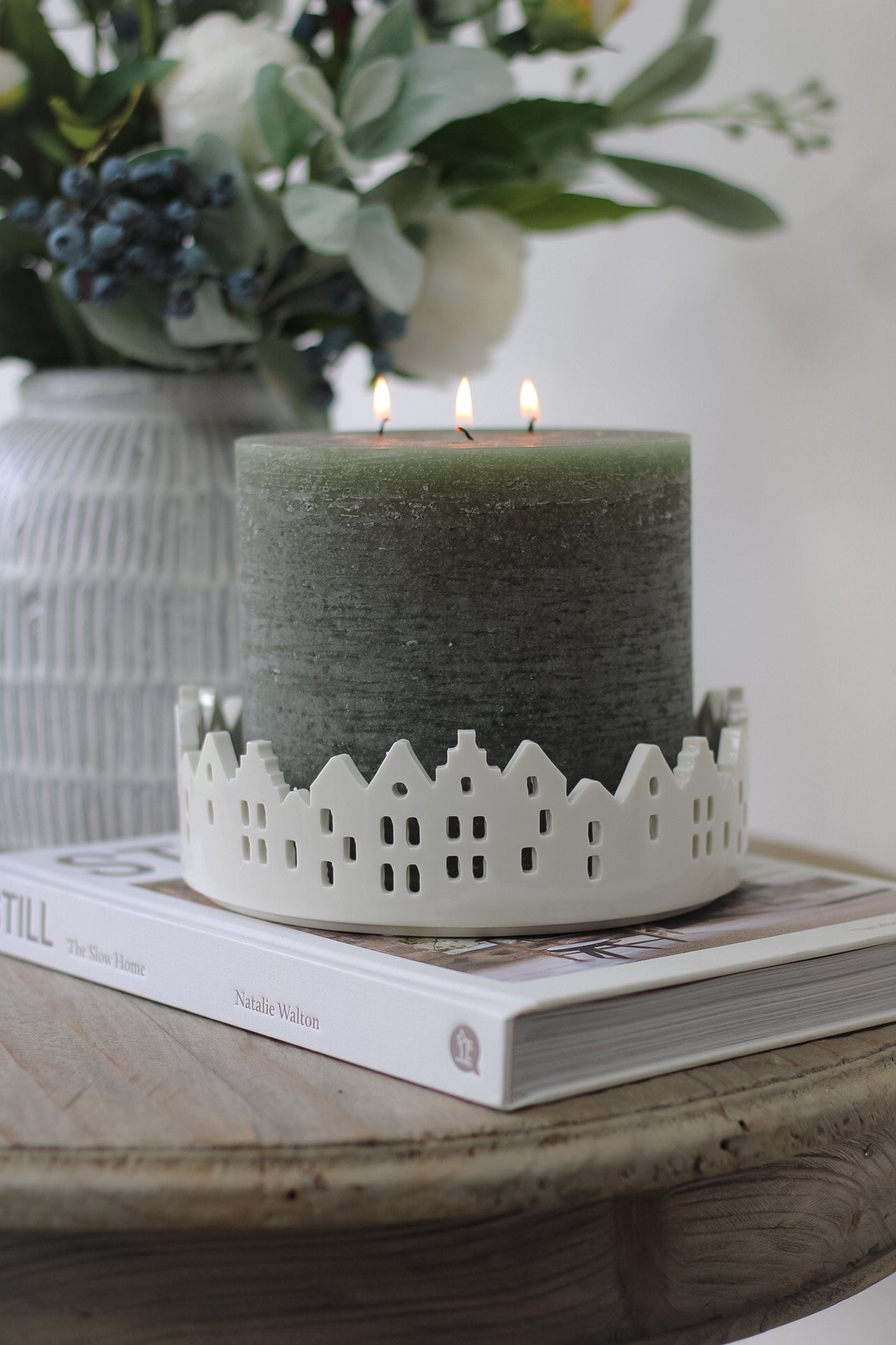 Moss green pillar candle in white ceramic house scene candle tray