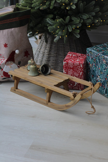 decorative wooden sleigh for christmas decorations under tree