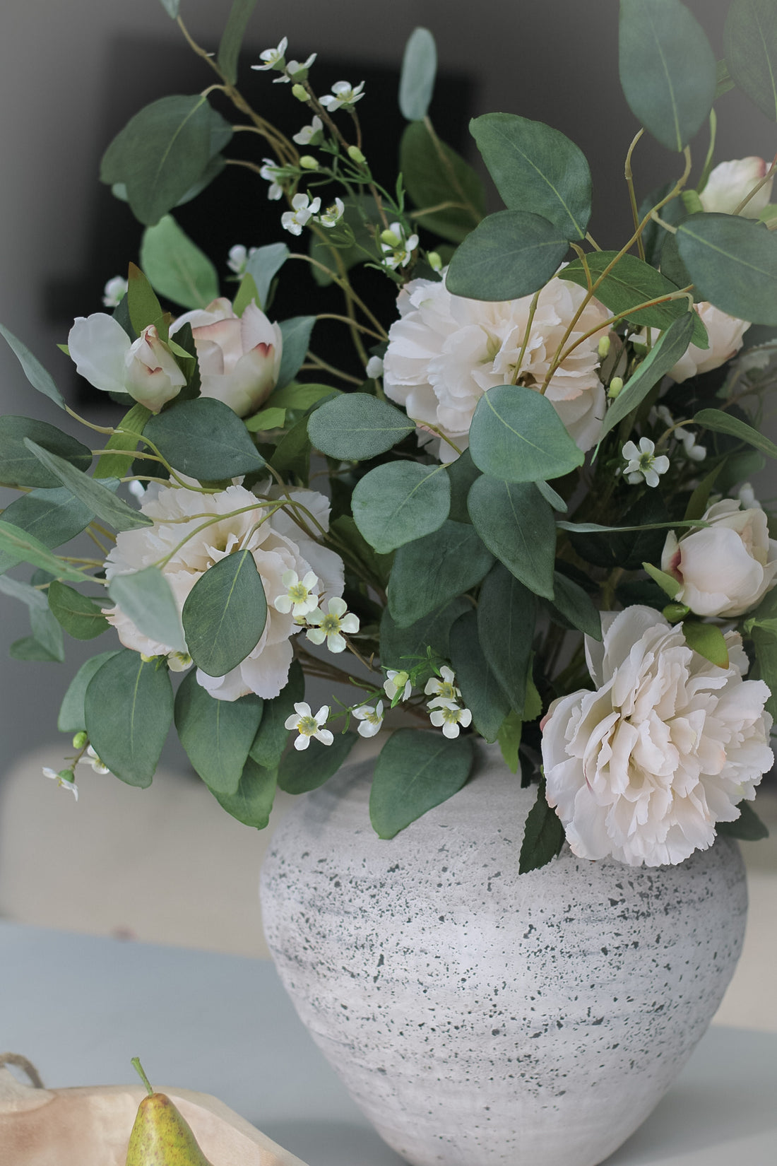 faux peonies and eucalyptus in vase