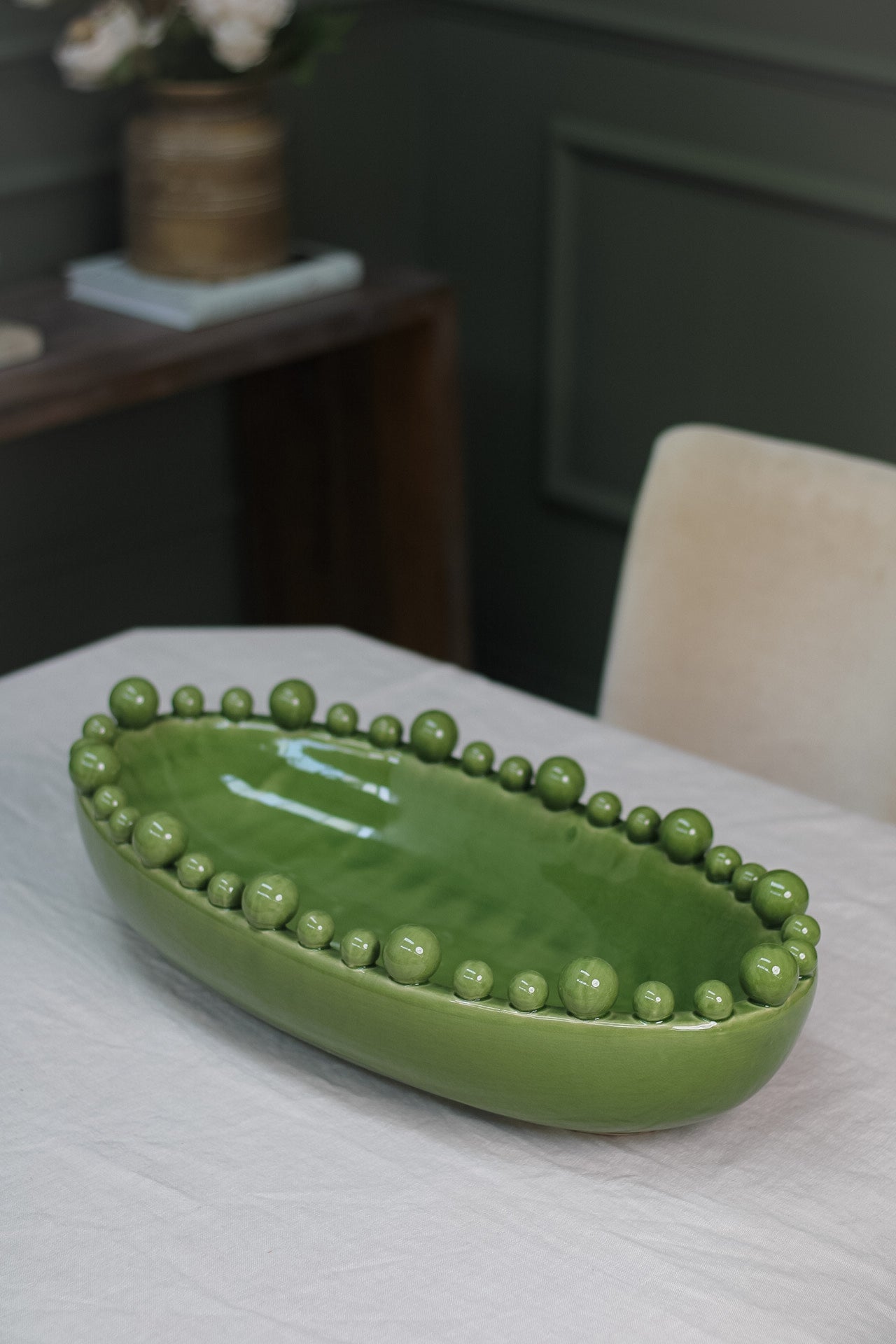 Green oval bobble bowl on dining table