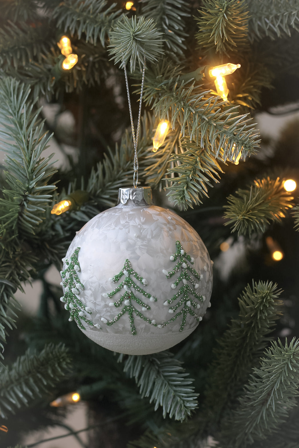 Silver christmas tree decoration with delicate green trees perfect for adding a scandi touch to your christmas tree hangers