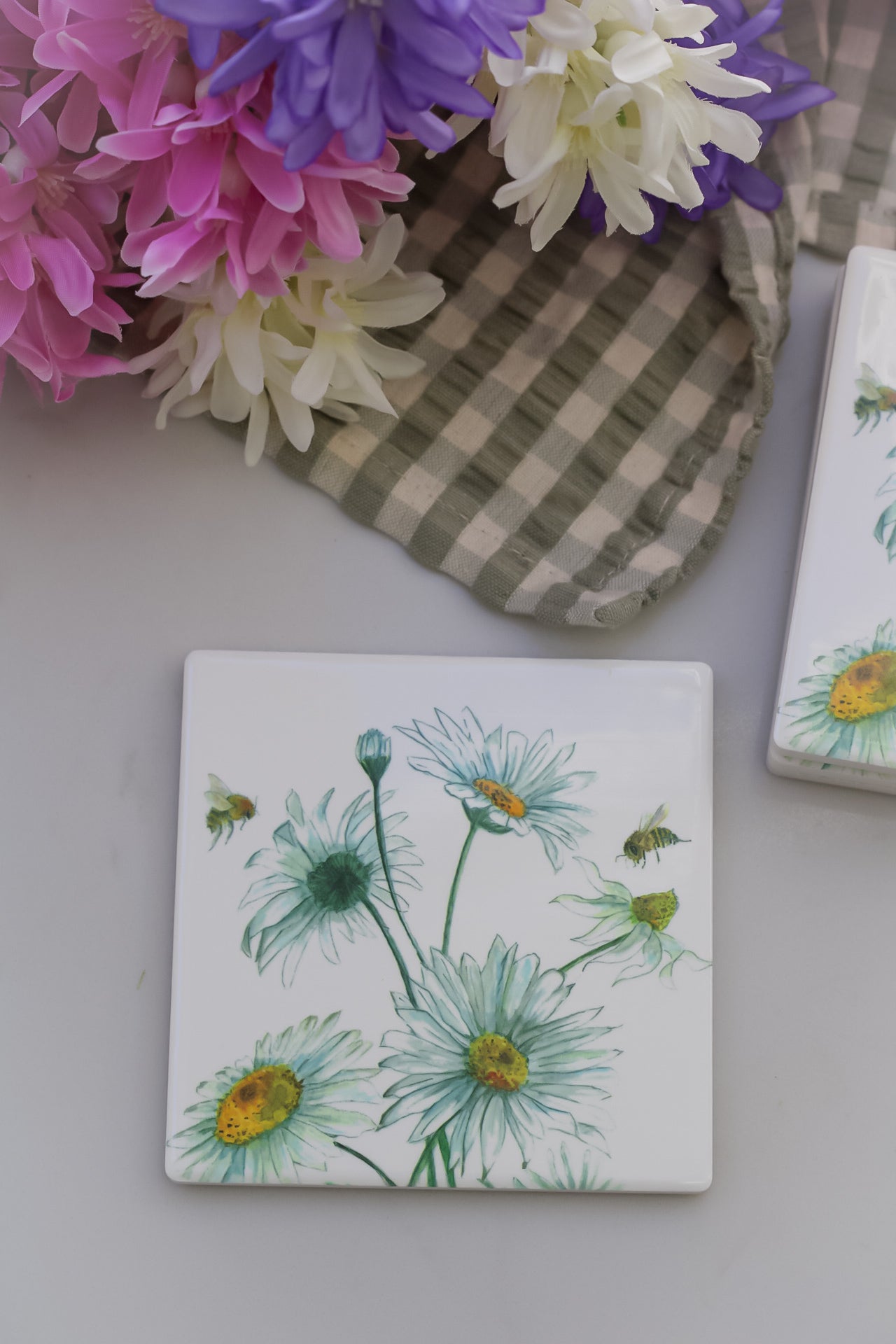 white ceramic coasters with spring daisy design