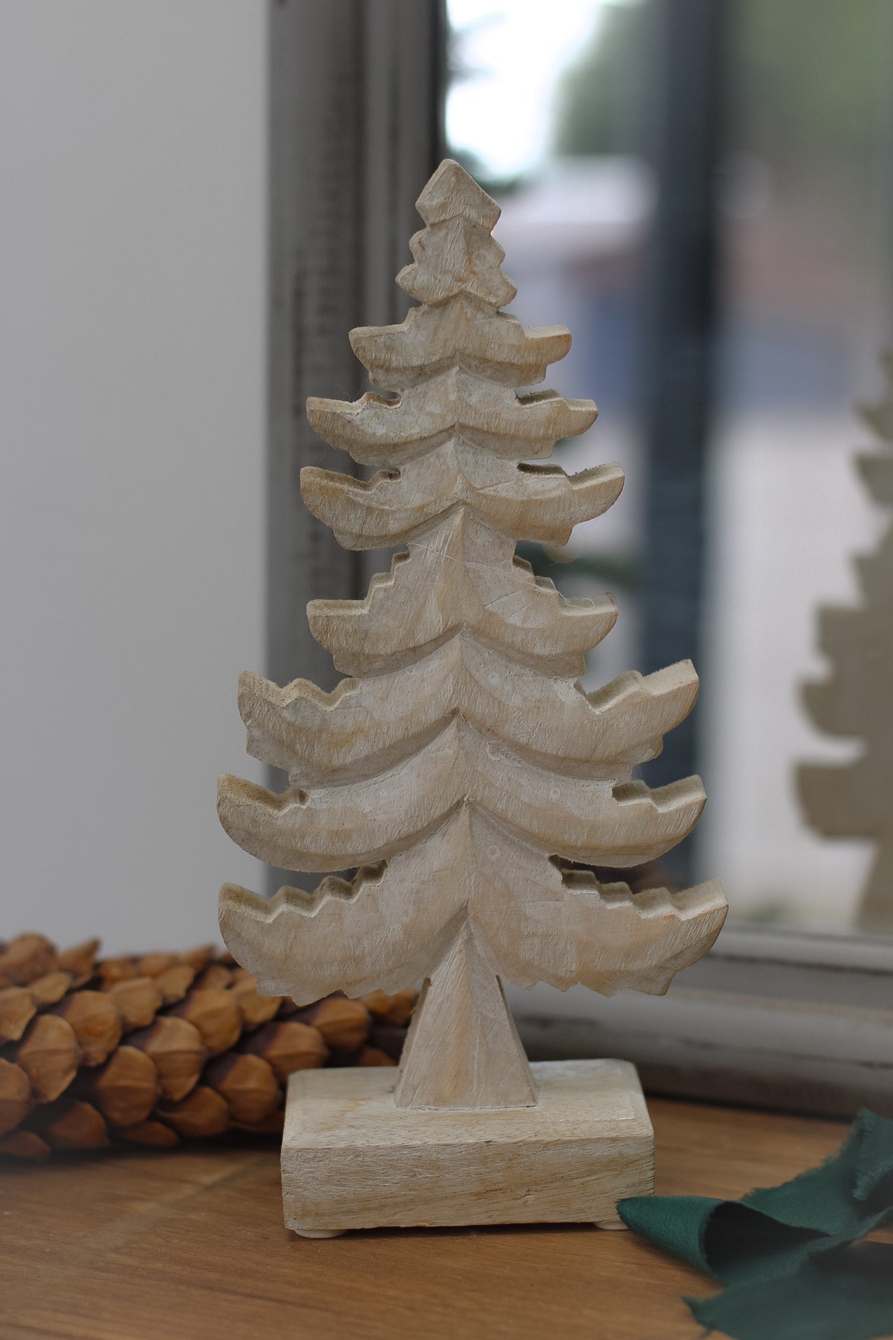 wooden christmas tree with pine cones