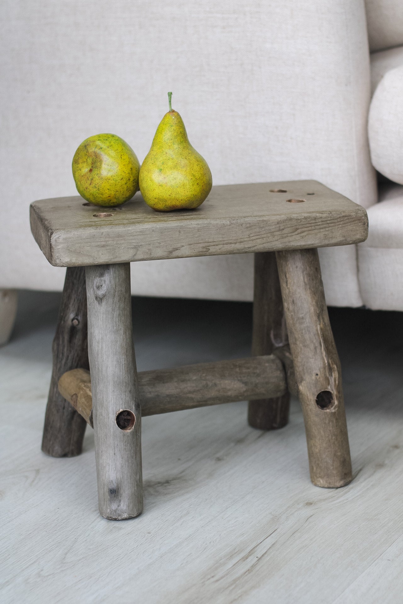 wooden stool by the side of sofa